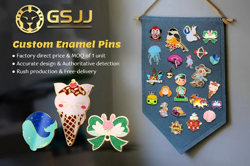 A promotional banner for "GSJJ Custom Enamel Pins" showing a collection of diverse enamel pins displayed on a gray felt banner, alongside three larger sample pins: a blue whale, an ice cream cone, and a green bow.