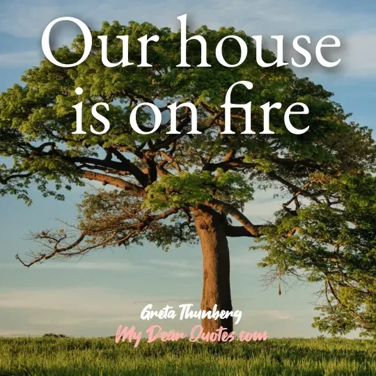 A quote from Greta Thunberg against a background of a large, mature tree with a wide canopy of green leaves and a thick trunk, set against a light blue sky and green grass. The quote reads: "Our house is on fire." Below the quote, it says "Greta Thunberg" and "My Dear Quotes.com".
