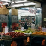 A small shop selling fruits and vegetables, symbolizing the essence of supporting small businesses through inspiring quotes and images.