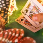 Poker chips, cards, and dice with famous poker quotes in the background. The scene is reminiscent of a dimly lit, smoky back room of a casino with soft, sepia-toned lighting. The poker chips are scattered haphazardly, with a few cards fanned out, and the dice are clustered together in a small group. The quotes are integrated into the background, adding a layer of meaning and narrative to the image.