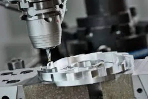 A close-up of a CNC milling machine's cutting tool actively shaping a metal workpiece with precision.