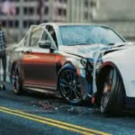 Two severely damaged cars after a collision on a city street, with a person standing by one of the vehicles, illustrating the aftermath of a car accident.