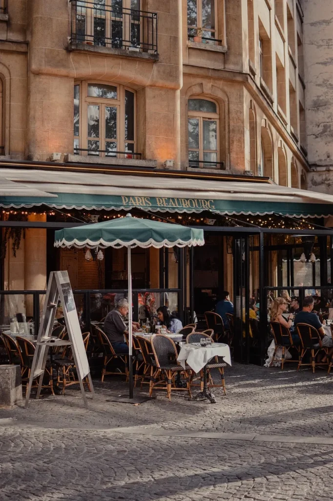 A Parisian cafe with outdoor seating and a sign that reads "Paris Beaubourg."