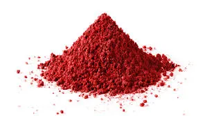 A vibrant pile of fine, deep red powder, likely a natural food coloring derived from ingredients like beetroot or berries, on a white background.