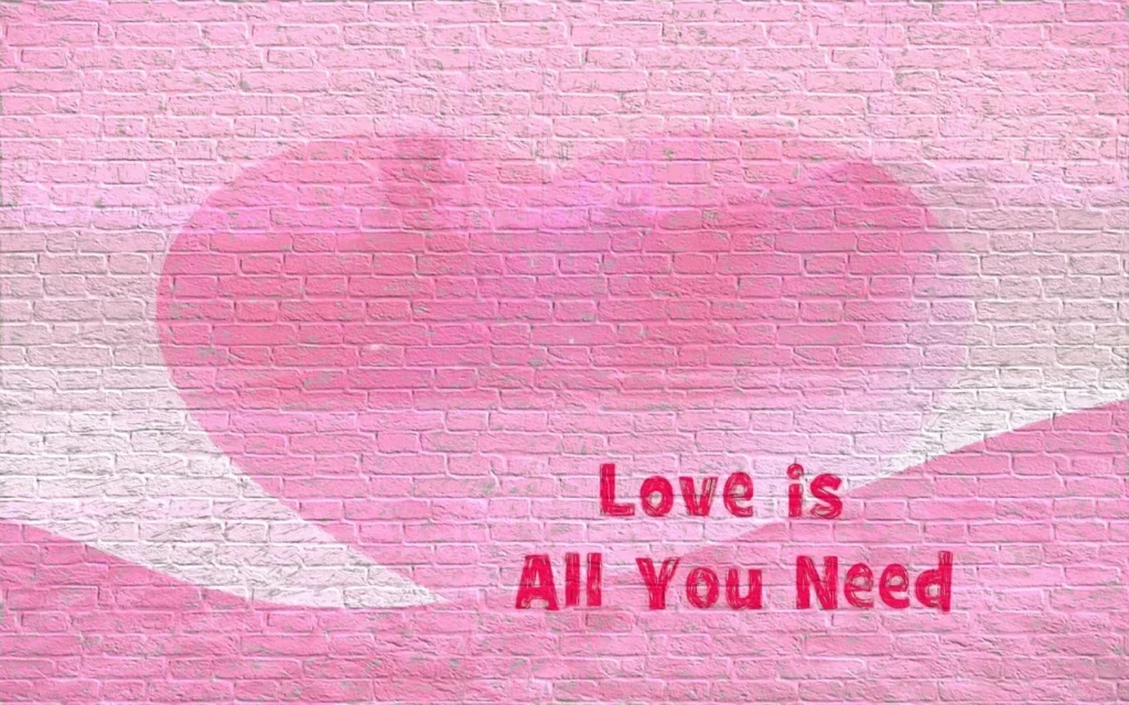 A pink and red image featuring a faint heart shape over a pink brick wall texture, with the quote "Love is All You Need" written in the bottom right corner.