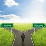 An illustration showing a businessman standing at a fork in a road, facing two large green signs pointing in opposite directions, labeled "Active" and "Passive," symbolizing the choice between different income strategies, like using AI for passive income.