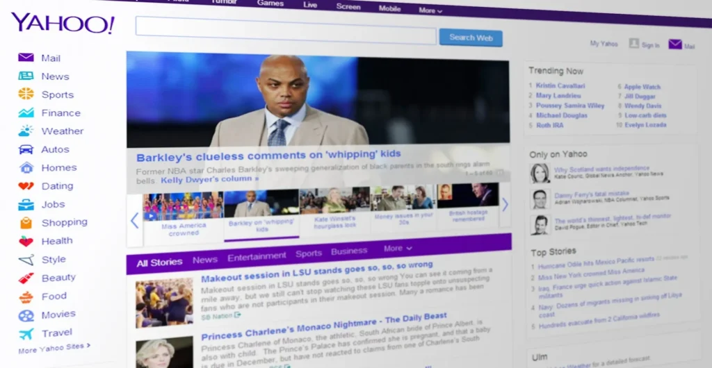 A perspective shot of the Yahoo.com homepage from the mid-2010s, featuring news headlines, a search bar, and the iconic purple branding.